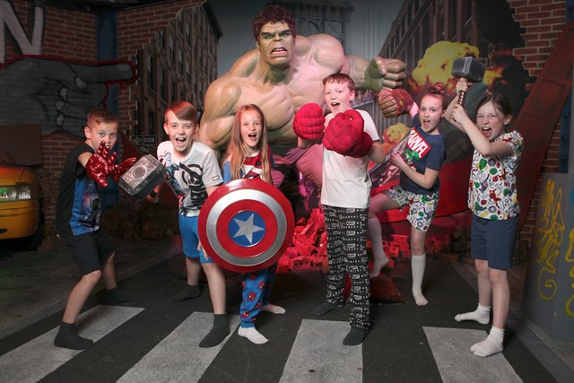 Children taking a picture next to the Hulk wax figure at Madame Tussauds Blackpool