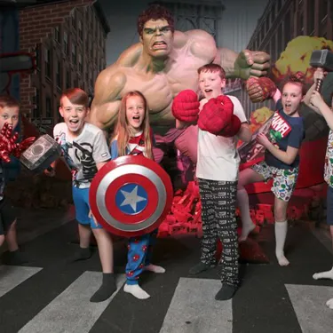 Children taking a picture next to the Hulk wax figure at Madame Tussauds Blackpool