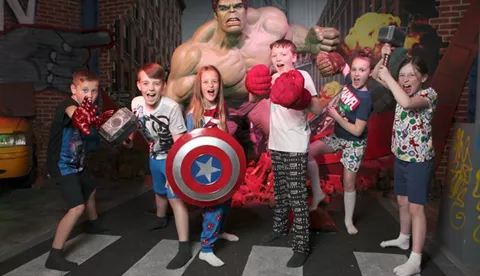 Children taking a picture next to the Hulk wax figure at Madame Tussauds Blackpool